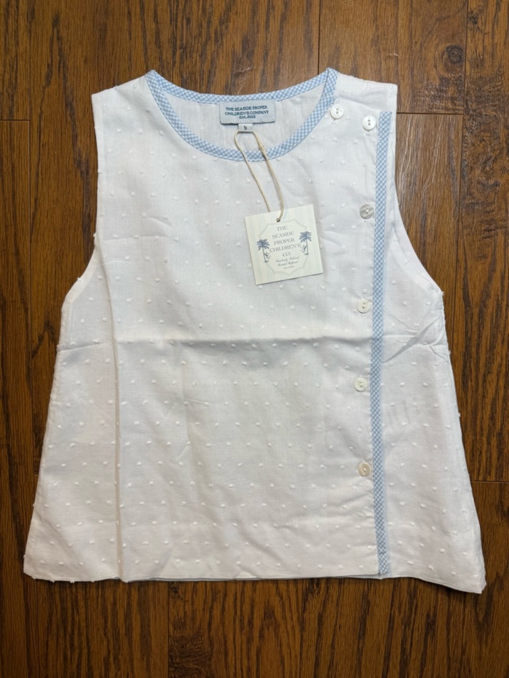 The Seaside Proper Children’s Co. White Swiss Dot Sleeveless Top with Blue Trim
